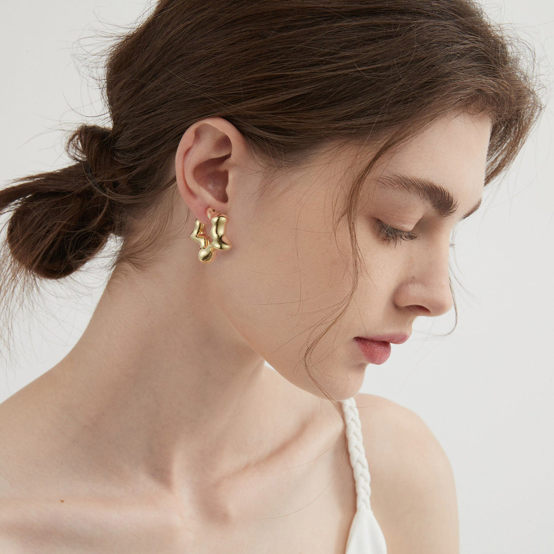 Golden-colored, open-ended five-pointed star earrings