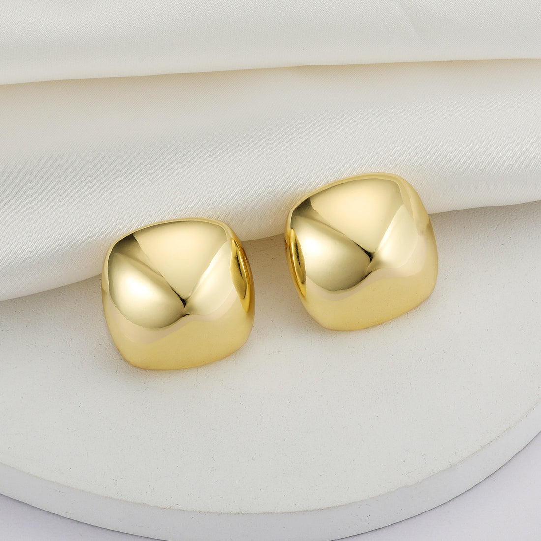 Golden, round quadrilateral earrings
